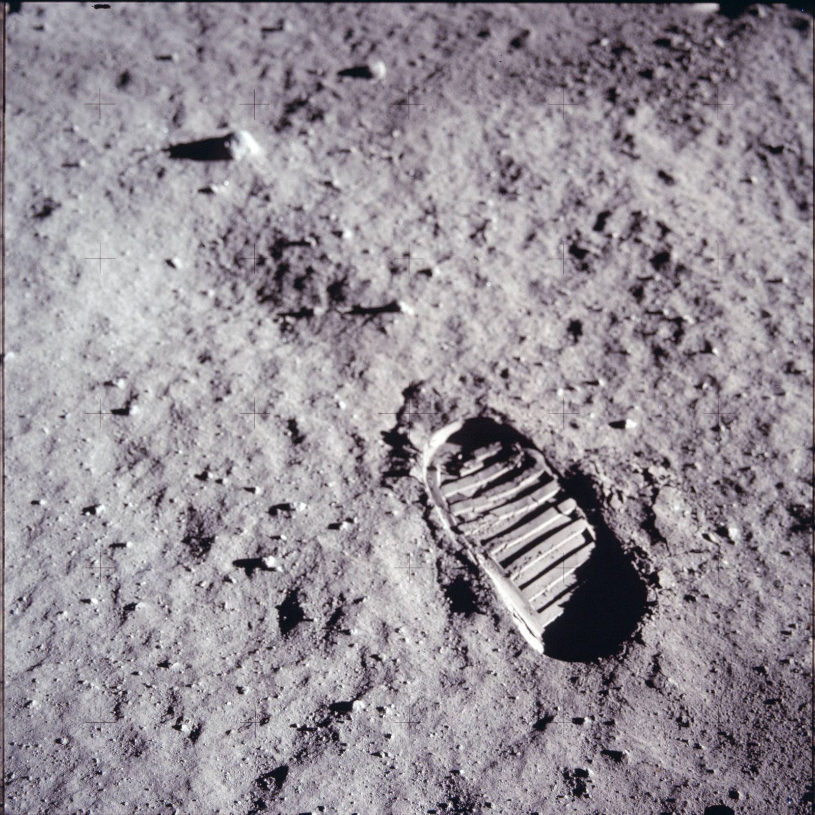 A bootprint pressed about 1 inch into the lunar regolith, demonstrating the soil's fineness and cohesion (AS11-40-5878, NASA).