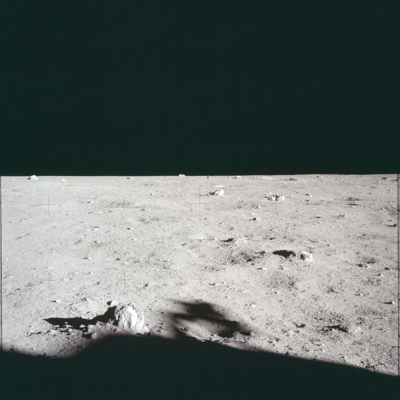 The lunar-surface television camera on its tripod northwest of the LM, its shadow stretching toward the photographer (AS11-40-5883, NASA).