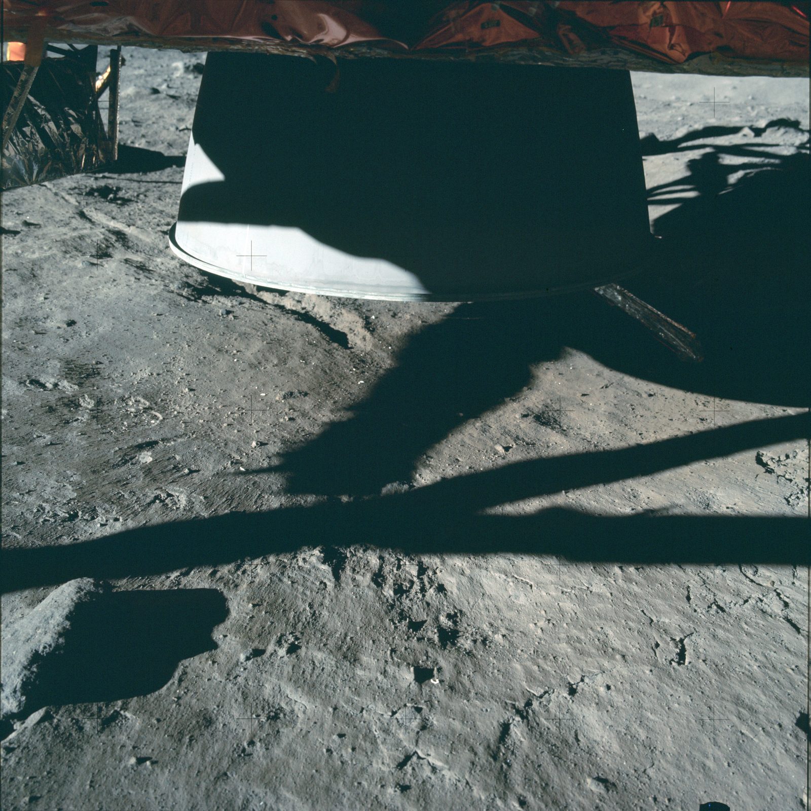 The LM descent-engine nozzle resting just above undisturbed regolith — the engine left no crater (AS11-40-5921, NASA).