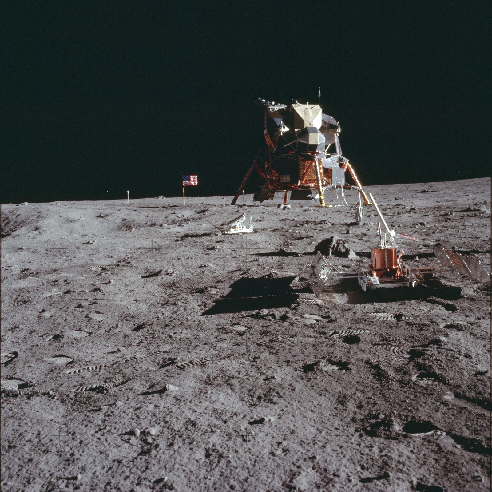 The deployed Passive Seismic Experiment Package on the surface, the LM beyond — the instrument that returned the first seismic look inside the Moon (AS11-40-5950, NASA).